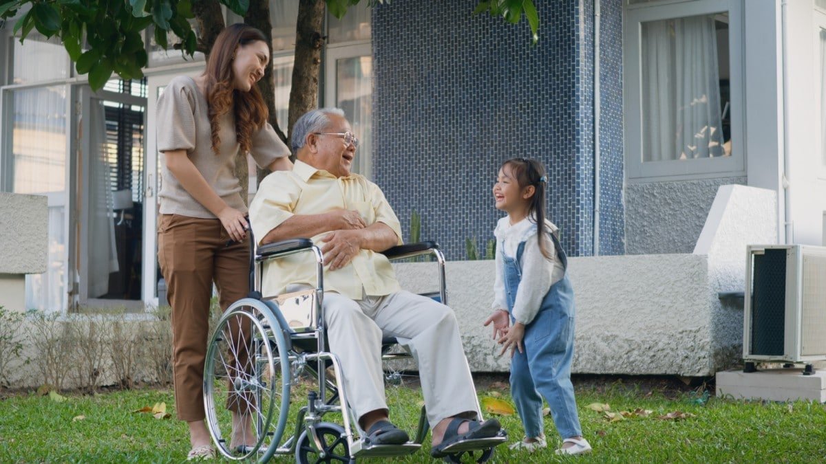 Grandpa in a wheelchair with family
